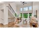 Sun-filled living room with two-story windows and wrought iron staircase at 1400 Squire Ln, Cumming, GA 30041