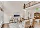 Cozy living room with wrought iron staircase, tall ceilings, and warm lighting at 1400 Squire Ln, Cumming, GA 30041