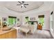 Main bedroom with tray ceiling, carpeted floors, sitting area, and large windows with green views at 1400 Squire Ln, Cumming, GA 30041