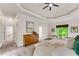 Spacious main bedroom with sitting area, carpeted floors, tray ceiling, and large windows with green views at 1400 Squire Ln, Cumming, GA 30041