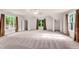 Spacious main bedroom with tray ceiling, carpet floors, and lots of natural light at 1400 Squire Ln, Cumming, GA 30041