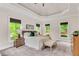 Main bedroom with carpeted floors, tray ceiling, night stands and large windows with green views at 1400 Squire Ln, Cumming, GA 30041