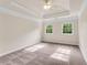 Bright main bedroom boasts carpet flooring, tray ceiling, and plenty of natural light at 1400 Squire Ln, Cumming, GA 30041