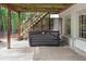 Covered patio area with hot tub installation, stairs to the deck, and privacy lattice at 1400 Squire Ln, Cumming, GA 30041