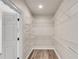 Spacious walk-in closet with white wire shelving and wood floor at 1400 Squire Ln, Cumming, GA 30041