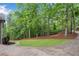 Scenic view of the home's vast yard with mature trees and a winding driveway at 1400 Squire Ln, Cumming, GA 30041