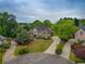 Beautiful home nestled on a lush, manicured lot with mature trees and a circular driveway at 2049 Kinderton Manor Dr, Johns Creek, GA 30097