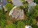 Spacious house with a large driveway, back patio, and meticulously maintained landscaping at 2049 Kinderton Manor Dr, Johns Creek, GA 30097