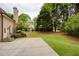 Spacious backyard with a well-manicured lawn, beautiful landscaping, and a charming patio area at 2049 Kinderton Manor Dr, Johns Creek, GA 30097