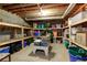 Unfinished basement storage area with ample shelving and natural light at 2049 Kinderton Manor Dr, Johns Creek, GA 30097