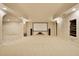 Finished basement media room with projector screen and neutral carpeting at 2049 Kinderton Manor Dr, Johns Creek, GA 30097