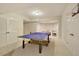 Basement game room features ping pong table and recreational area at 2049 Kinderton Manor Dr, Johns Creek, GA 30097