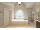 Elegant bathroom with soaking tub, glass shower and decorative arched window at 2049 Kinderton Manor Dr, Johns Creek, GA 30097