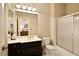 Clean bathroom featuring a white countertop vanity, framed mirror, and a glass sliding door shower at 2049 Kinderton Manor Dr, Johns Creek, GA 30097