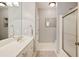 Bathroom featuring a vanity with sink, framed mirror, patterned rug, and glass-door shower at 2049 Kinderton Manor Dr, Johns Creek, GA 30097