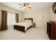 Bedroom with carpet, a window, a ceiling fan, and a queen sized bed with decorative pillows at 2049 Kinderton Manor Dr, Johns Creek, GA 30097
