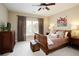 Cozy bedroom featuring a sleigh bed, hardwood furniture, curtains, and a ceiling fan at 2049 Kinderton Manor Dr, Johns Creek, GA 30097