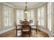 Charming breakfast nook bathed in sunlight with plantation shutters providing privacy and a cozy atmosphere at 2049 Kinderton Manor Dr, Johns Creek, GA 30097