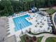 Community pool with a slide, splash pad, lounge chairs, and shaded seating areas at 2049 Kinderton Manor Dr, Johns Creek, GA 30097