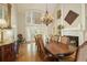 Elegant dining room featuring a fireplace, chandelier, and large window illuminating a dining table at 2049 Kinderton Manor Dr, Johns Creek, GA 30097