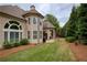 Exterior view of two-story home with a lush green lawn and landscaping at 2049 Kinderton Manor Dr, Johns Creek, GA 30097
