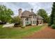 Stately two-story home with manicured lawn and mature trees at 2049 Kinderton Manor Dr, Johns Creek, GA 30097