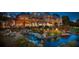 Luxurious home exterior at twilight, enhanced by a beautiful water feature and outdoor lighting at 2049 Kinderton Manor Dr, Johns Creek, GA 30097