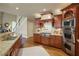 Kitchen featuring granite countertops, stainless steel appliances, and an open concept design with a view to the living area at 2049 Kinderton Manor Dr, Johns Creek, GA 30097