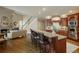 Modern kitchen featuring granite counters, bar seating, stainless appliances, and a seamless transition to the living room at 2049 Kinderton Manor Dr, Johns Creek, GA 30097