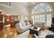 Bright living room featuring hardwood floors, large windows, and an open floor plan with a view of the kitchen at 2049 Kinderton Manor Dr, Johns Creek, GA 30097