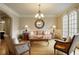 Inviting living room featuring hardwood floors, elegant furnishings, and natural light at 2049 Kinderton Manor Dr, Johns Creek, GA 30097