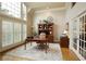 Bright home office with large windows, hardwood floors, and custom built-ins at 2049 Kinderton Manor Dr, Johns Creek, GA 30097