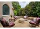 Cozy outdoor seating area with comfortable chairs, a fire pit, and a view of the surrounding greenery at 2049 Kinderton Manor Dr, Johns Creek, GA 30097