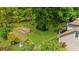 Aerial shot of the home shows lush greenery surrounding a fenced garden area and charming backyard at 2700 Sandstone Dr, Lawrenceville, GA 30043