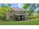 A covered patio with rocking chairs and an outdoor table overlooks the well-maintained backyard at 2700 Sandstone Dr, Lawrenceville, GA 30043