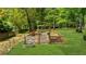 Wooden garden with metal planter in a well-manicured backyard setting surrounded by greenery at 2700 Sandstone Dr, Lawrenceville, GA 30043