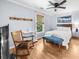 Cozy bedroom featuring hardwood floors, a ceiling fan, and a comfortable bed with a blue bench at 2700 Sandstone Dr, Lawrenceville, GA 30043