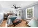 Inviting bedroom featuring hardwood floors, two windows, and a comfortable bed with a gray throw at 2700 Sandstone Dr, Lawrenceville, GA 30043