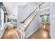 Light-filled foyer with hardwood floors, white staircase, and views to the dining room at 2700 Sandstone Dr, Lawrenceville, GA 30043