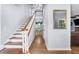 Bright foyer featuring hardwood floors, staircase, and view of dining room in a neutrally decorated home at 2700 Sandstone Dr, Lawrenceville, GA 30043