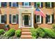 Charming front entrance with brick steps, black door, an American flag, and well-maintained landscaping at 2700 Sandstone Dr, Lawrenceville, GA 30043