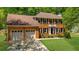 Traditional brick home featuring a two-car garage, manicured lawn, and charming architectural details at 2700 Sandstone Dr, Lawrenceville, GA 30043