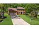 Two story brick home with an American flag, two-car garage and a sprawling front lawn at 2700 Sandstone Dr, Lawrenceville, GA 30043