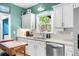 Bright kitchen featuring stainless steel appliances, granite counters, and white cabinets at 2700 Sandstone Dr, Lawrenceville, GA 30043