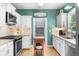 Modern kitchen with white cabinets, subway tile backsplash, stainless steel appliances, and hardwood floors at 2700 Sandstone Dr, Lawrenceville, GA 30043