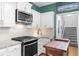 Kitchen showcasing stainless steel appliances, granite counters, and white cabinetry at 2700 Sandstone Dr, Lawrenceville, GA 30043