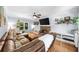 Inviting living room featuring a stone fireplace, hardwood floors, and a comfortable leather sectional sofa at 2700 Sandstone Dr, Lawrenceville, GA 30043