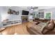Cozy living room showcasing hardwood floors, a stacked stone fireplace, and a comfortable sectional sofa at 2700 Sandstone Dr, Lawrenceville, GA 30043