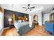 Spacious primary bedroom featuring hardwood floors, paneled accent wall and tray ceiling at 2700 Sandstone Dr, Lawrenceville, GA 30043