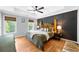 Comfortable bedroom with hardwood floors, tray ceiling, paneled accent wall and ample natural light at 2700 Sandstone Dr, Lawrenceville, GA 30043